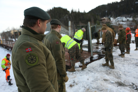 Norwegian officers from their movement control unit supervise the rail operations as U.S. Marines prepare the loading ramp to drive armored vehicles on train cars. Rail cars are one of several transportation options used to move U.S. Marine Corps fighting vehicles and equipment throughout the region. Hell, Norway was the location where HMMWVs and other vehicles were loaded and transported to the location where they would train with the Telemark Battalion. Cold Response 16 improves capabilities between NATO allies and partners and creates a foundation for future cooperation. This exercise enables the NATO alliance to work together and demonstrate both our unwavering commitment to our collective defense under the North Atlantic Treaty and our ability to counter transnational threats.